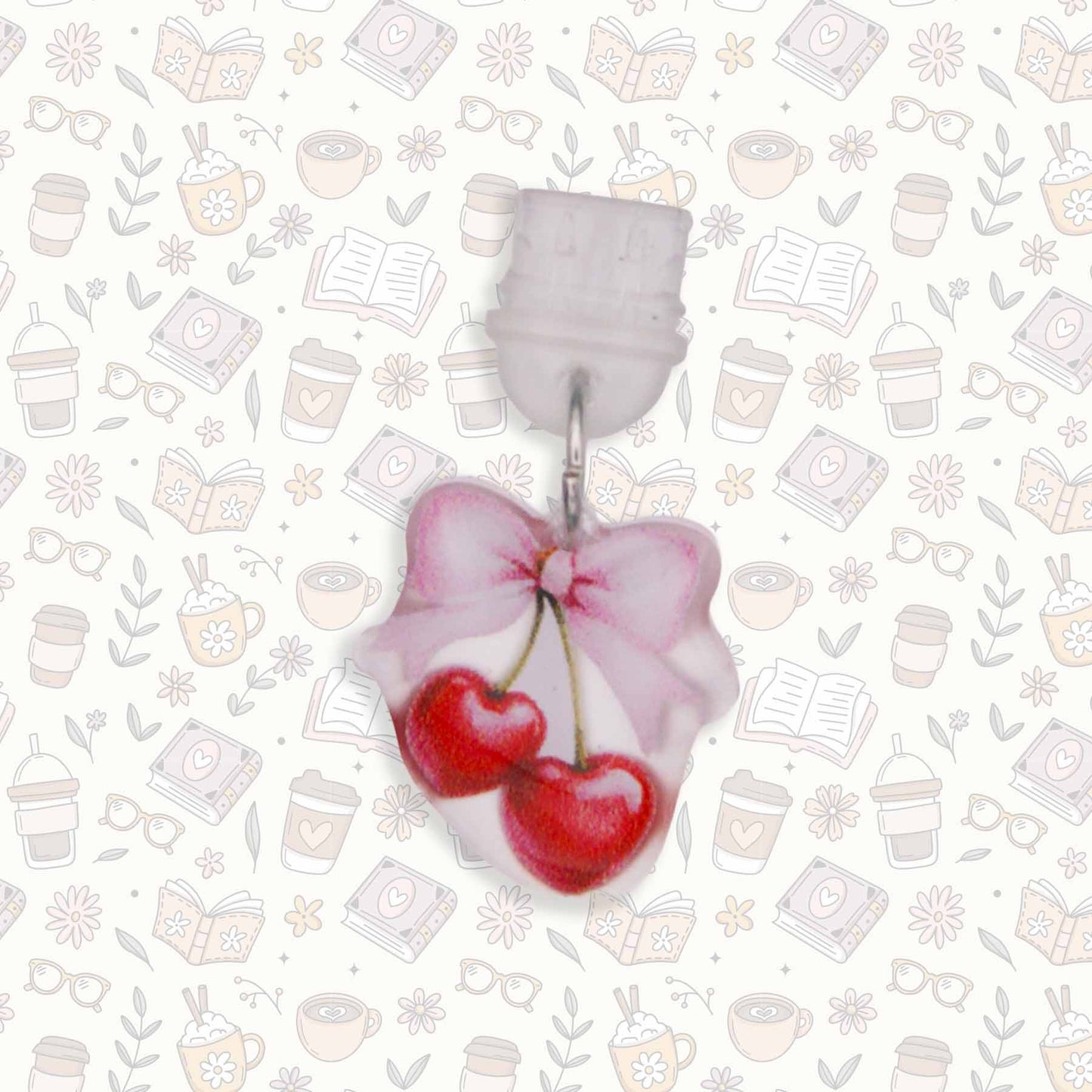 Cherries & Bow Kindle Charm, a USB-C dust plug, showing two red heart-shaped cherries and a pink bow on a white background with bookish doodles
