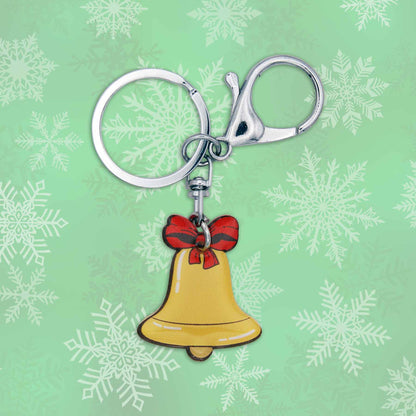 Christmas jingle bell bag charm keychain with red bow on a green snowy background.