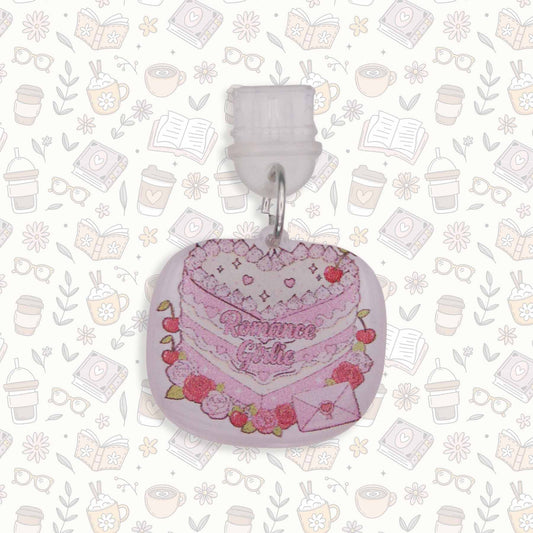 Romance Girlie Cake Kindle Charm with pink icing, cherries, and roses, on a busy pattern background