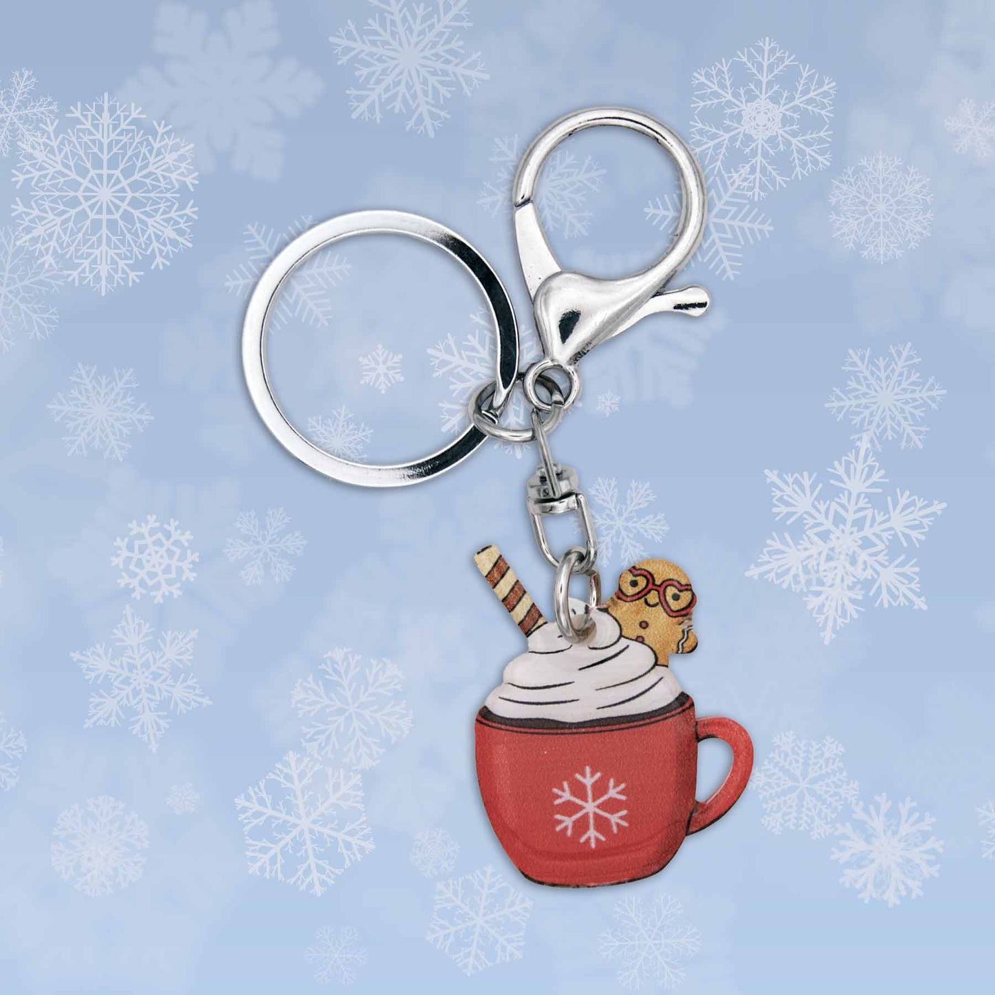 Winter Hot Cocoa Bag Charm Keychain: Red mug with whipped cream, gingerbread man, and striped wafer on snowflake background.