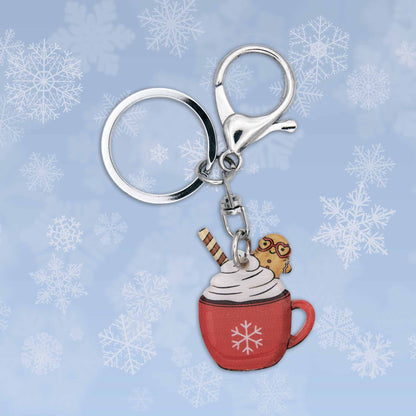 Winter Hot Cocoa Bag Charm Keychain: Red mug with whipped cream, gingerbread man, and striped wafer on snowflake background.