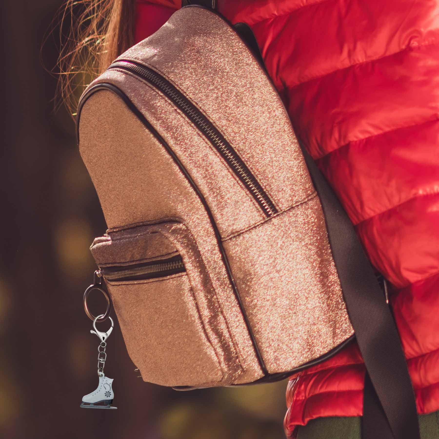 Christmas ice skate bag charm keychain on a shimmering gold backpack, perfect winter accessory or holiday accessory.