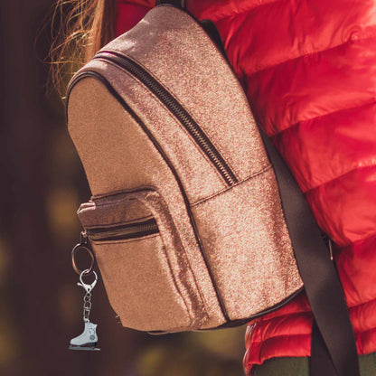 Christmas ice skate bag charm keychain on a shimmering gold backpack, perfect winter accessory or holiday accessory.