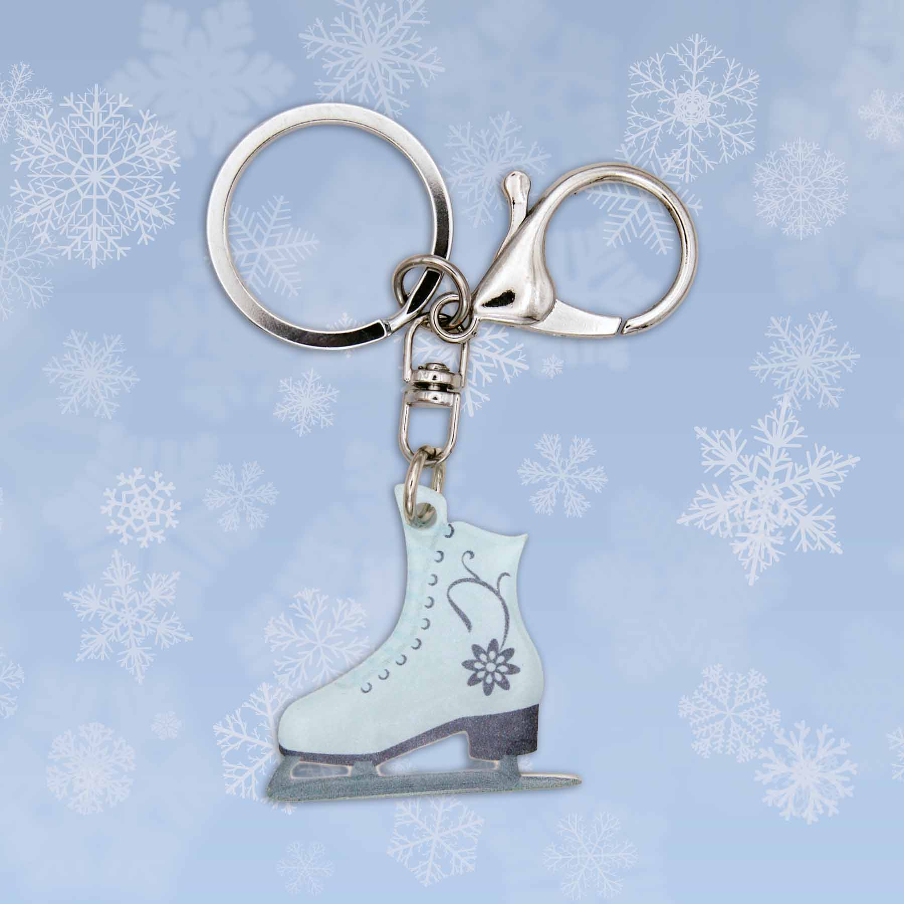 Christmas ice skate bag charm keychain, light blue with floral design, silver keyring, and claw clasp