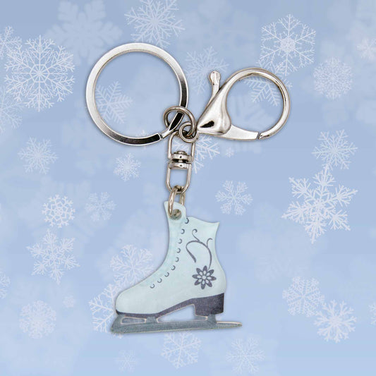 Christmas ice skate bag charm keychain, light blue with floral design, silver keyring, and claw clasp